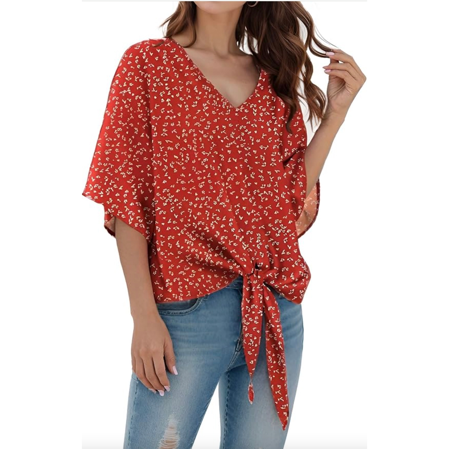 Red floral chiffon blouse with a V-neck and short sleeves, featuring a tie-front detail. Paired with light-wash distressed jeans.