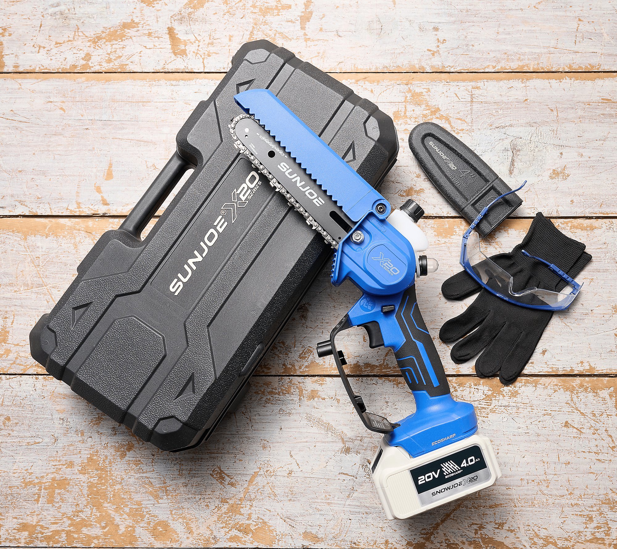 Battery-powered mini chainsaw kit with 20V battery, goggles, gloves, and protective case.