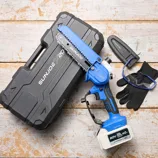 Battery-powered mini chainsaw kit with 20V battery, goggles, gloves, and protective case.
