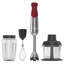 A stick blender set with a red handle, accompanied by accessories: a measuring blender cup, a whisk attachment, and a food processor bowl with lid.