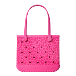 Pink bag with a leopard print pattern and circular perforations, featuring long handles and \“bogg\“ branding on the bottom edge.