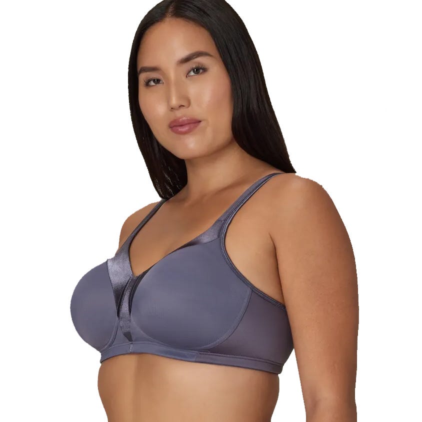 A woman is wearing a gray sports bra with wide straps and minimalistic design.