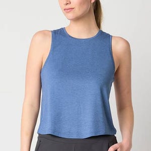 Woman wearing a sleeveless blue tank top with a crew neckline.
