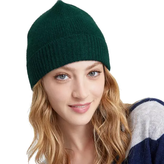 A person wearing a green knit beanie and a blue and gray striped sweater.