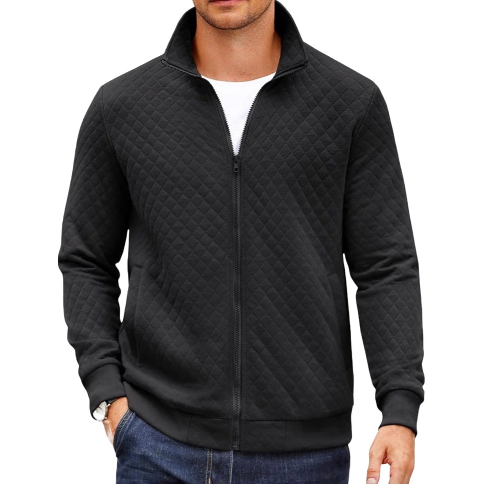 A black, quilted zip-up jacket paired with a white shirt and jeans. The jacket features a high collar and ribbed cuffs.