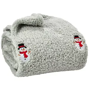 A gray, fluffy blanket featuring embroidered snowmen wearing black hats and red scarves.