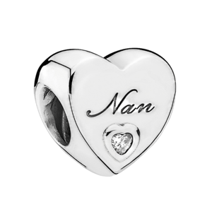 Silver heart-shaped charm with \“Nan\“ engraved, featuring a small heart-shaped crystal.