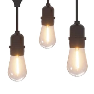 Three pendant lights with vintage-style Edison bulbs and black sockets emit a warm glow.