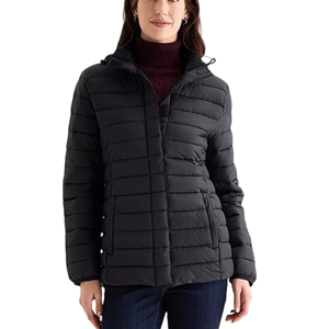A woman is wearing a black puffer jacket with a hood over a maroon turtleneck sweater, paired with dark jeans.