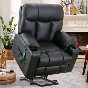 Black leather recliner with cup holders, side pocket, and lift-assist feature, set in a cozy living room with plants, a rug, and a fireplace.
