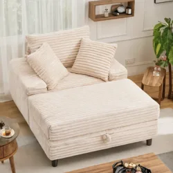 A cream-colored, ribbed fabric sofa with two pillows, featuring an extended chaise. It is placed in a living room setting with wooden and modern decor elements.