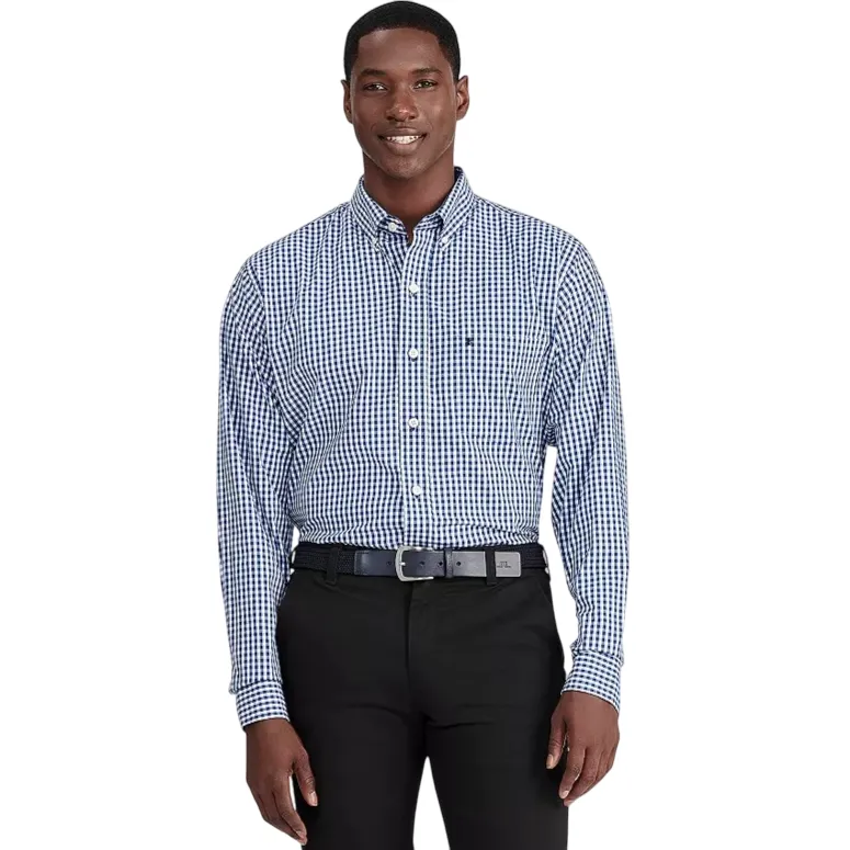 Man wearing a navy and white checkered button-up shirt and black pants with a black belt.