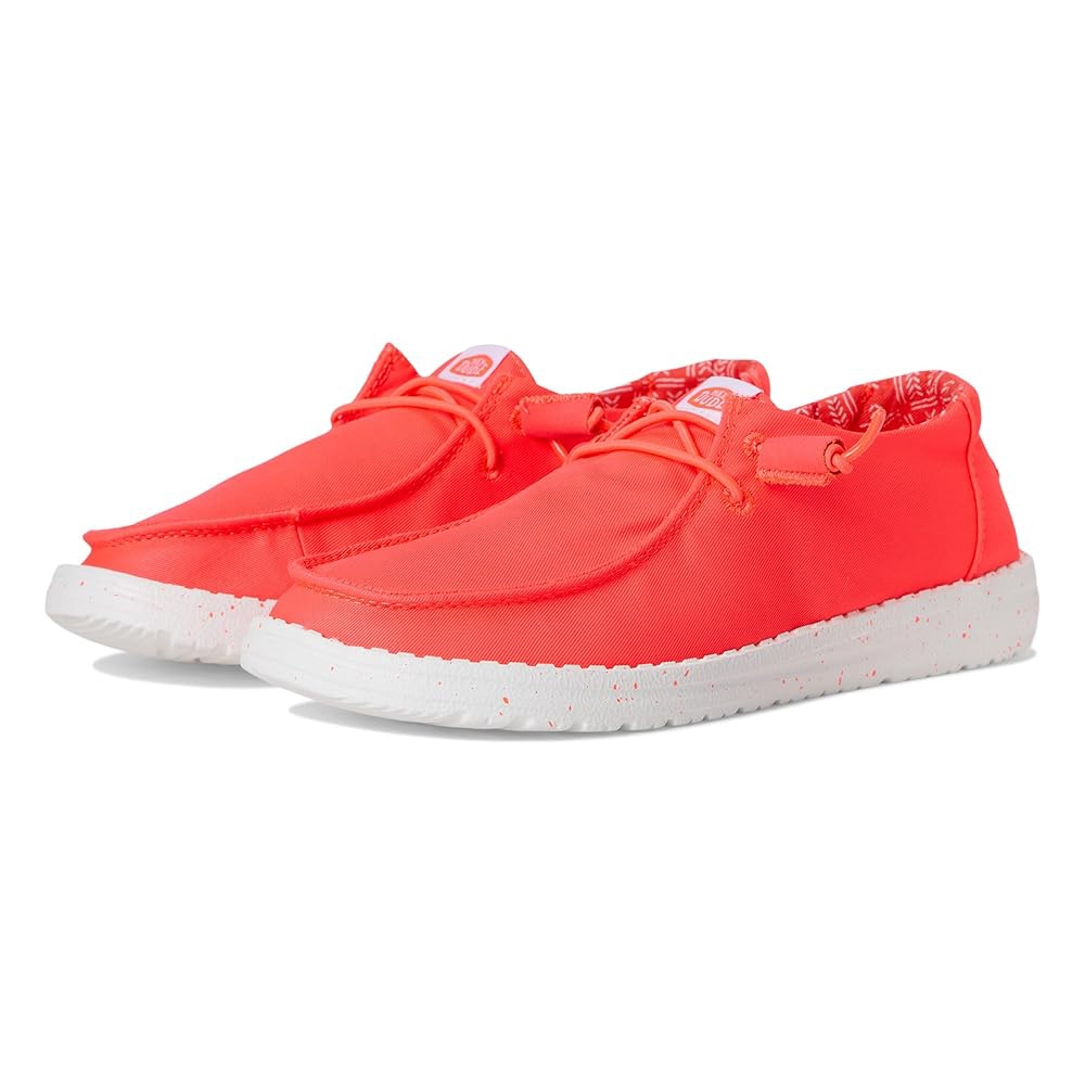 Bright coral slip-on shoes with a lightweight, flexible design, featuring elastic lace-up detailing and a speckled white sole for casual comfort.