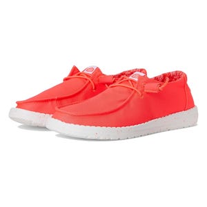 Bright coral slip-on shoes with a lightweight, flexible design, featuring elastic lace-up detailing and a speckled white sole for casual comfort.