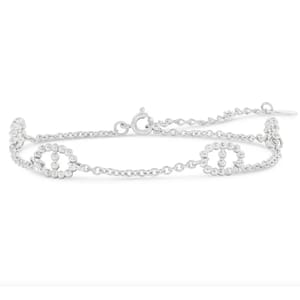 Silver ankle bracelet with a mix of link and beaded designs, featuring a lobster clasp closure.