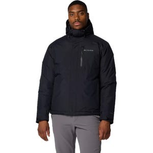 A man wearing a black Columbia hooded jacket and light gray pants.