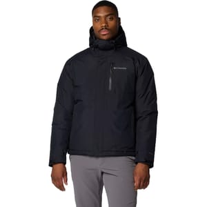 A man wearing a black Columbia hooded jacket and light gray pants.