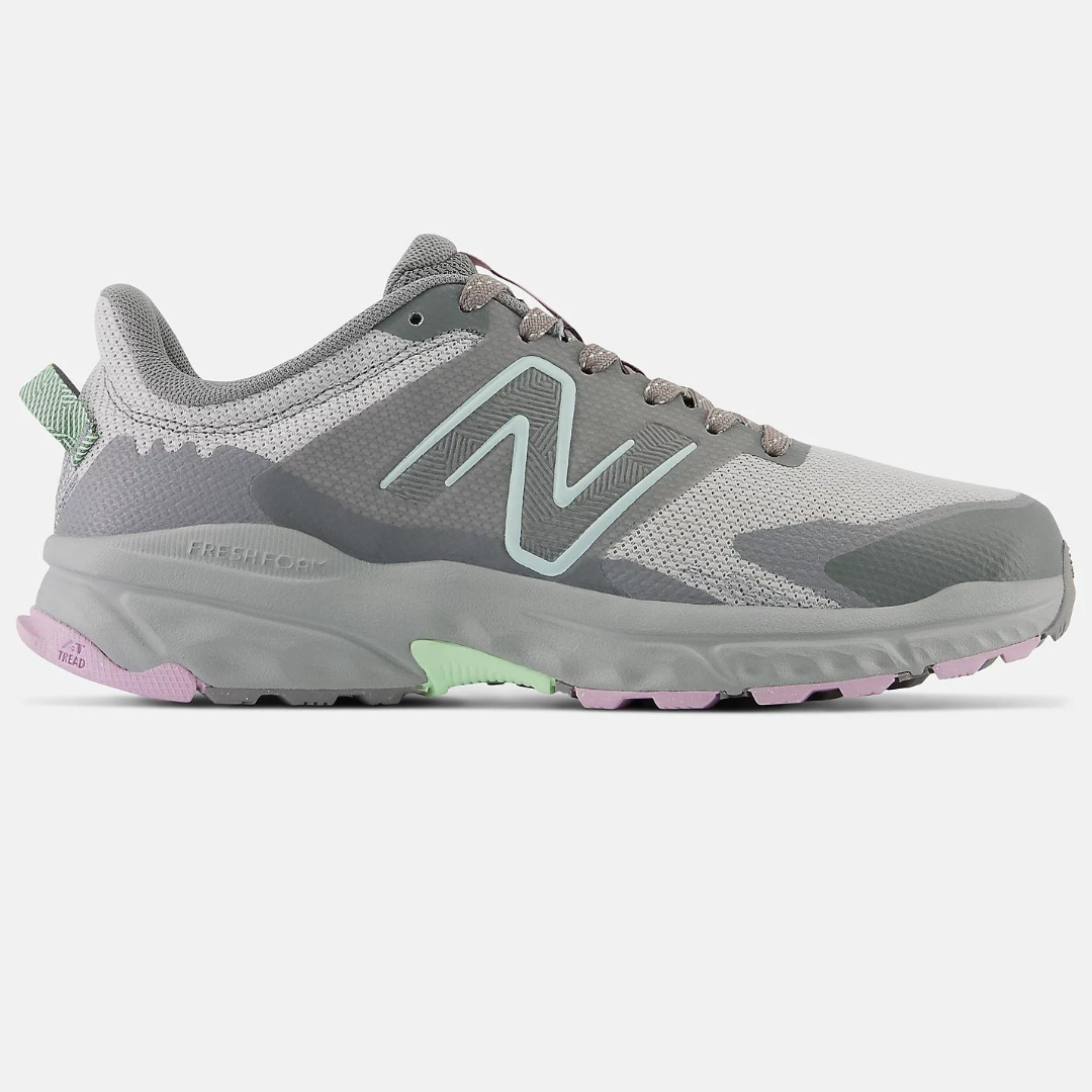 A pair of gray New Balance running shoes with green and pink accents.