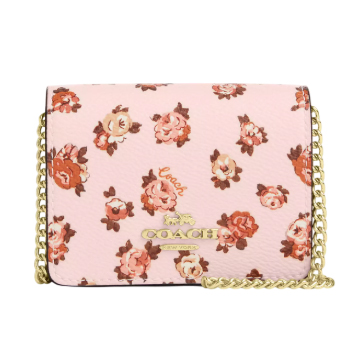 A pink Coach Outlet Mini Wallet on a Chain featuring a floral print with red and pink roses and a gold chain strap. The Coach logo is embossed in gold on the front.