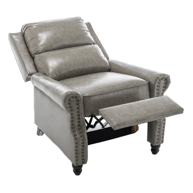 A gray faux-leather recliner with plush cushioning, nailhead trim, and a footrest. Designed for comfort, it features rolled arms and a classic, stylish appearance.
