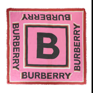 Pink square scarf featuring a large central \“B\“ with \“BURBERRY\“ repeated along the borders in black, accented with a red and white trim.