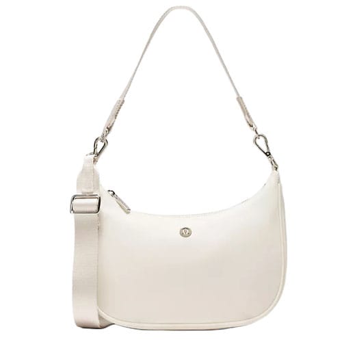 A cream-colored shoulder bag with a detachable strap, adjustable buckle, and silver hardware, featuring a small logo on the front.