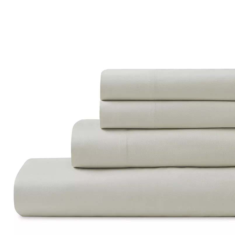 A folded, light gray sheet set, including a fitted sheet, flat sheet, and pillowcases, are stacked neatly.