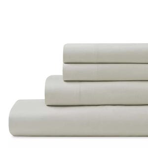 A folded, light gray sheet set, including a fitted sheet, flat sheet, and pillowcases, are stacked neatly.