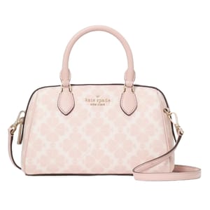 A light pink Kate Spade New York Spade Flower Small Dolly Duffle bag featuring a clover pattern, top handles, a detachable strap, and gold-tone hardware.