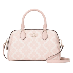 A light pink Kate Spade New York Spade Flower Small Dolly Duffle bag featuring a clover pattern, top handles, a detachable strap, and gold-tone hardware.