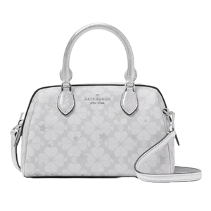 Kate Spade New York Spade Flower Star Clara medium dome satchel in white features a subtle floral star pattern, silver-tone handles, and an adjustable crossbody strap.