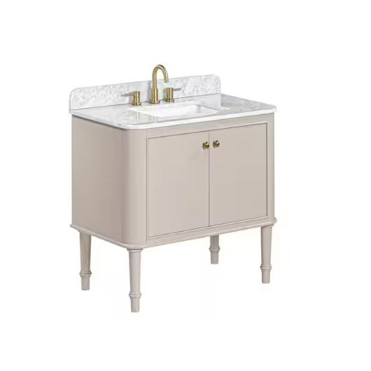 A freestanding bathroom vanity with a beige base, white marble countertop, and backsplash, featuring an undermount sink and brass faucet. It includes two cabinet doors and stands on slender legs.