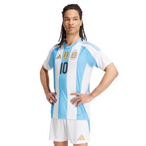 Adidas Messi Argentina jersey, featuring light blue and white vertical stripes, gold FIFA and AFA patches, and the number 10 on the front, paired with matching white shorts.