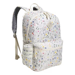 A white backpack with a floral print, featuring multiple compartments, adjustable padded straps, and a haul handle.