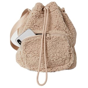 A beige sherpa drawstring backpack with a front zip pocket, featuring a phone partially visible in the pocket.