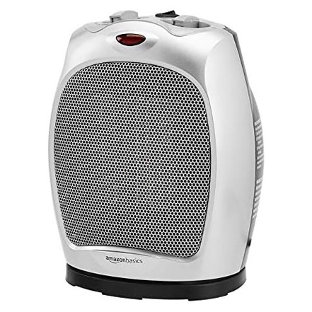 A compact, white oscillating ceramic heater with a black grille, red power indicator, and gray control knobs on top.