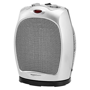 A compact, white oscillating ceramic heater with a black grille, red power indicator, and gray control knobs on top.