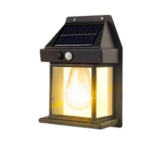 A wall-mounted solar-powered lantern with a motion sensor, featuring a classic design and warm light, is installed outdoors.