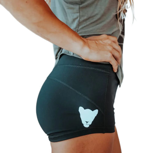 Person wearing black athletic shorts with a white lion head logo on the side.