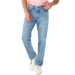 Man wearing light blue denim jeans with a pink shirt and white sneakers.