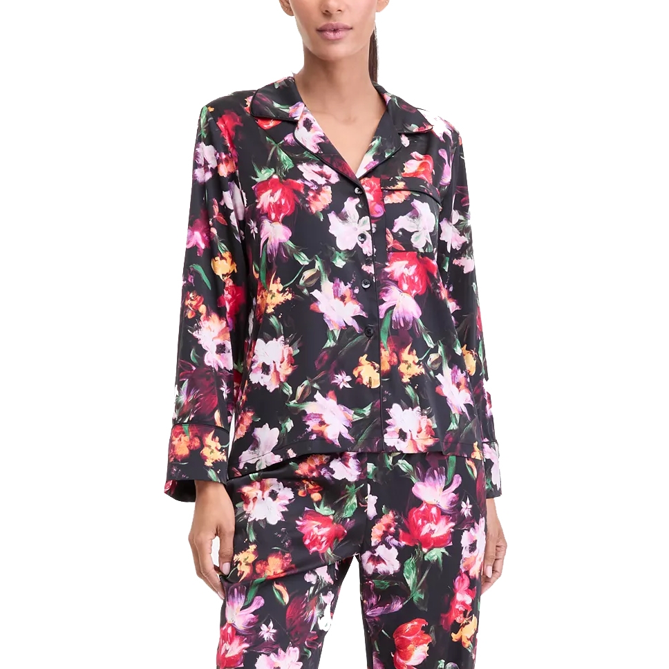 Floral-patterned pajama set featuring a button-up long-sleeve top and matching bottoms with a dark background and colorful flowers.