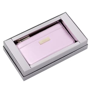 A pink Kate Spade slim cardholder is presented in a silver gift box. The cardholder features a zippered compartment and a gold-toned logo plaque.