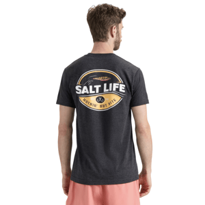 A man wearing a dark gray T-shirt with a \“Salt Life\“ logo on the back, saying \“Nothin' But Bite,\“ paired with pink shorts.