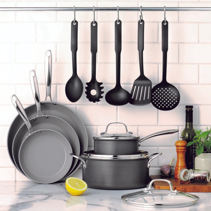 Kitchen utensils and cookware including pans, pots, and a collection of hanging cooking tools.