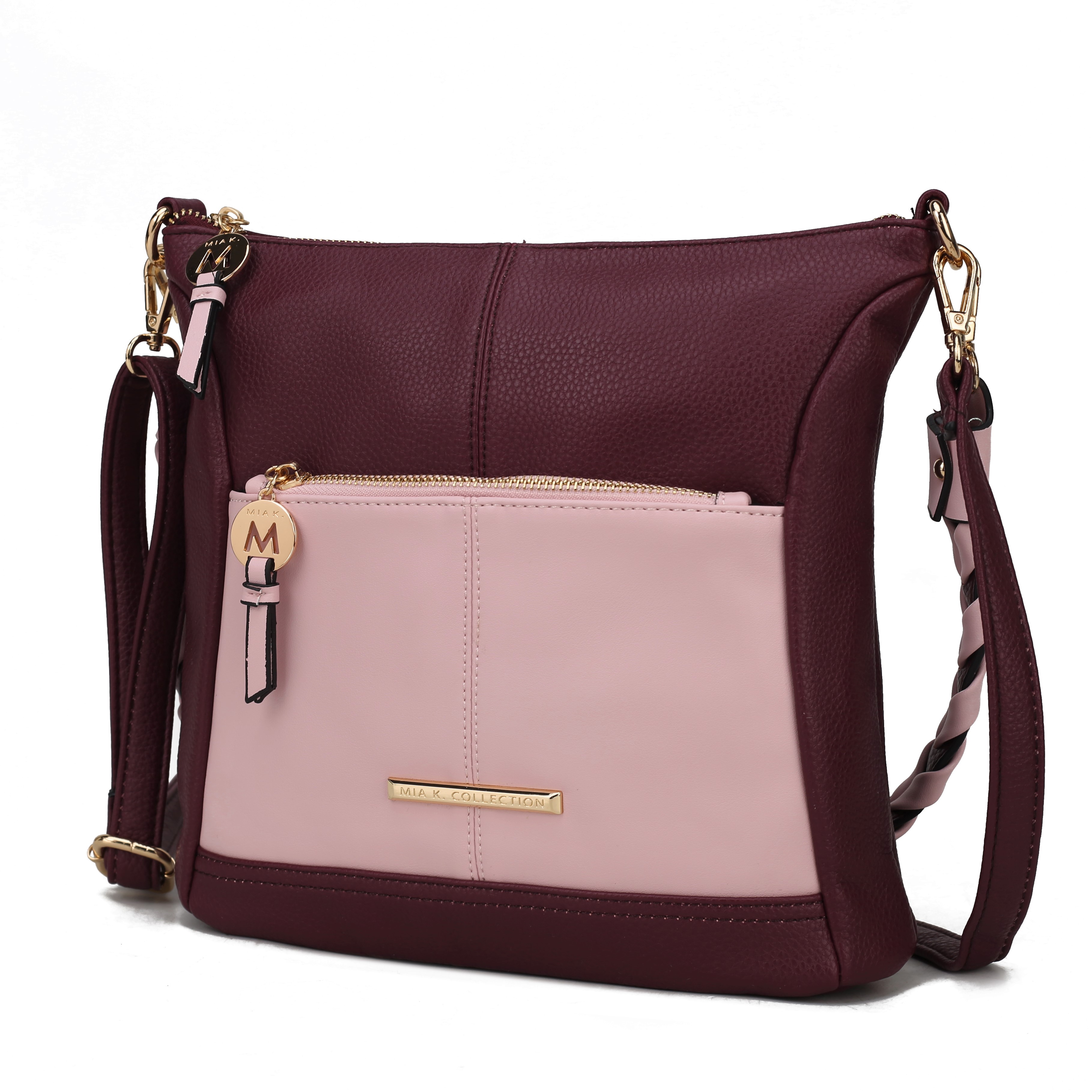 A two-toned burgundy and pink crossbody bag with gold-tone hardware, featuring a front zip pocket and adjustable strap.