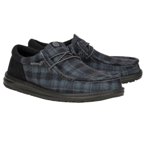 Hey Dude Wally Funk Shoes feature a soft checked plaid fabric in blue and black, with a moccasin-style design and lightweight sole for casual comfort.