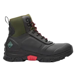 A rugged, mid-high boot featuring a black and green color scheme with red accents, sturdy laces, a durable grip sole, and a small \“Muck\“ logo on the side.