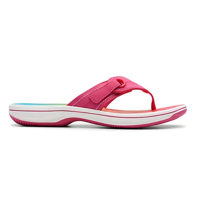 A pink flip-flop sandal with a white sole and a colorful insole, featuring a thong strap design.