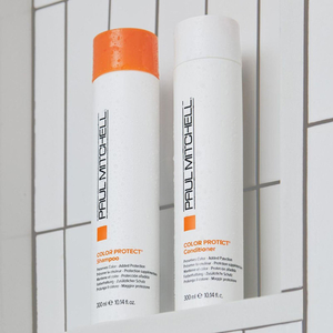 Two bottles of Paul Mitchell Color Protect Shampoo and Conditioner, each 300 ml, are placed against a tiled background.