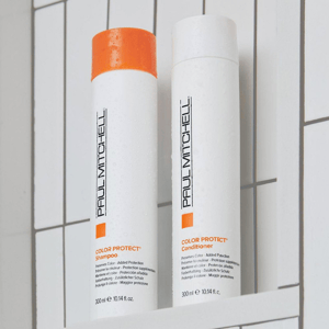 Two bottles of Paul Mitchell Color Protect Shampoo and Conditioner, each 300 ml, are placed against a tiled background.